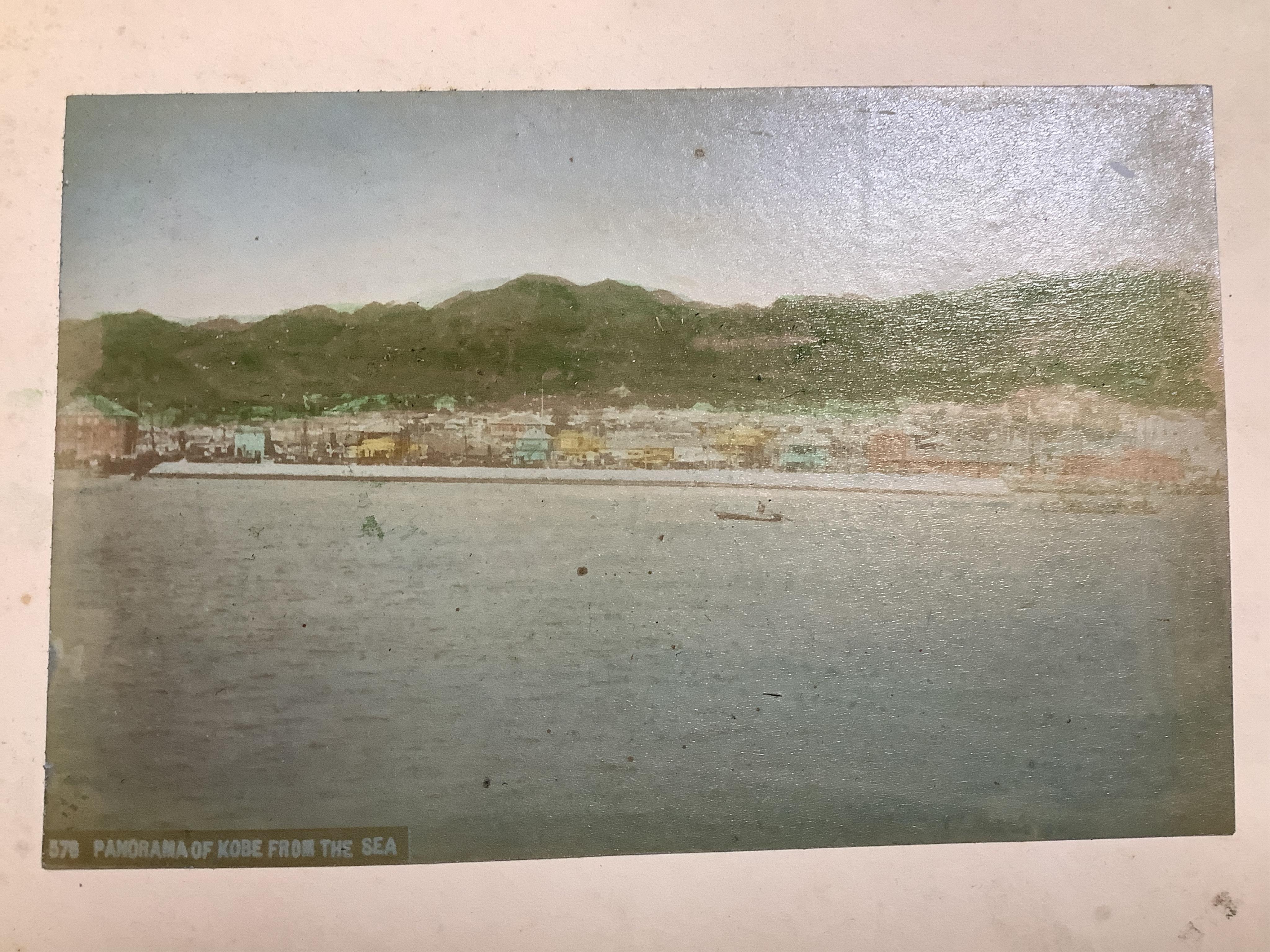 An early 20th century Japanese bone inlaid lacquer photograph album containing coloured photographs of people and Japanese scenes.19.5cm wide x 15.5cm high